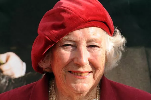Dame Vera Lynn wearing a red hat.